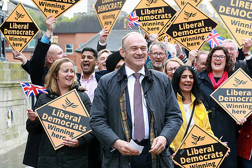Ed Davey in front of crowd with Lib Dem diamond signs